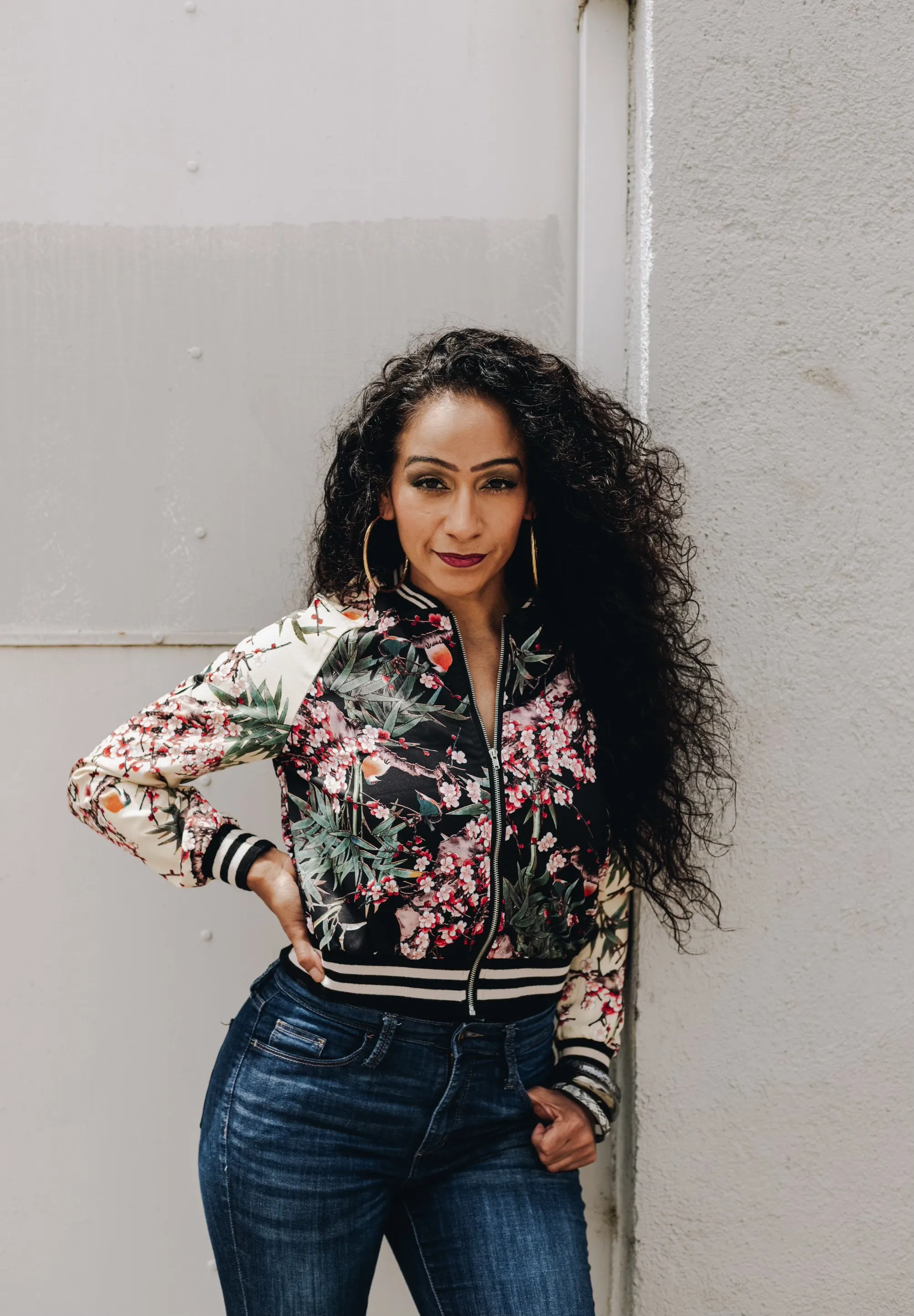 Woman in flower bomber jacket.